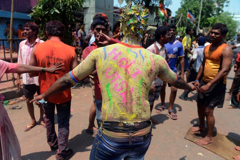 Indian men celebrating Holi in Mumbai