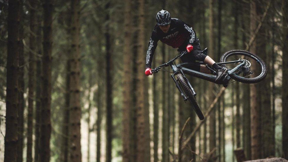 A cyclist doing a stunt on an e-bike