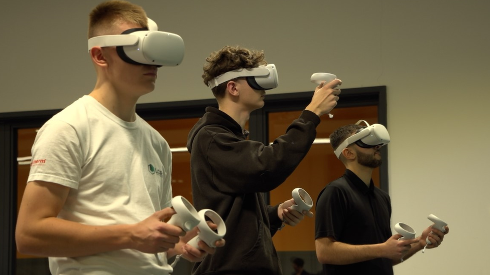 Students wearing virtual reality headsets that will be used in teaching