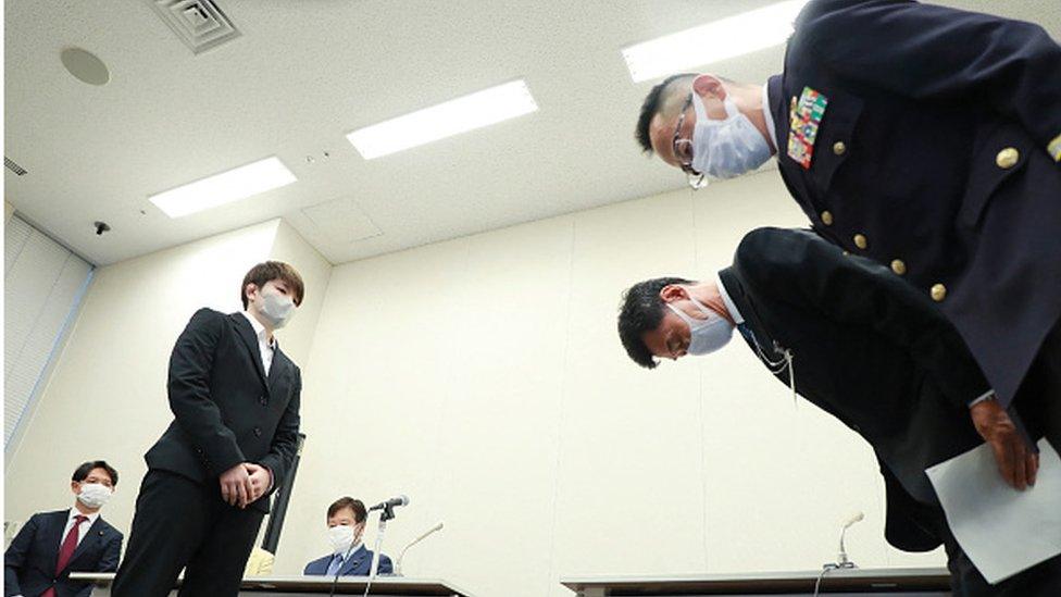 Members (R) of Japan's Ministry of Defense and Japan's Ground Self-Defense Force bowing to apologise to Rina Gono