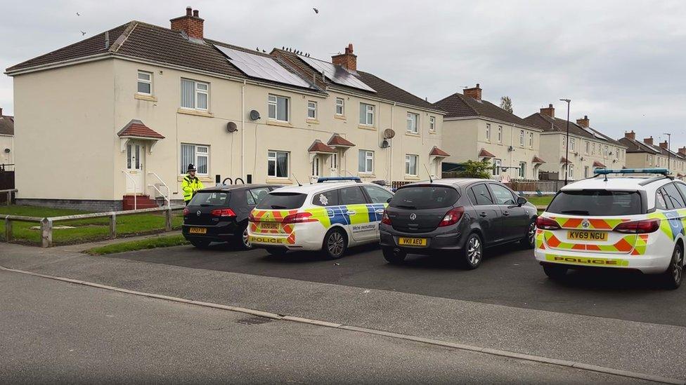 Police cars parked on Maple Terrace