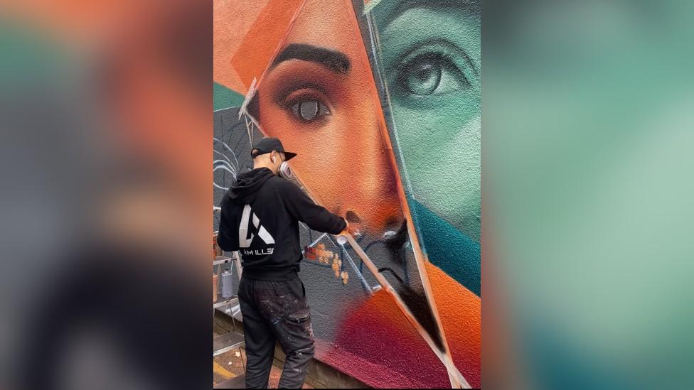 An artist creating a mural