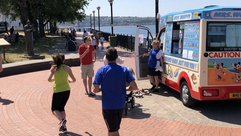 People in the sun at Cardiff Bay