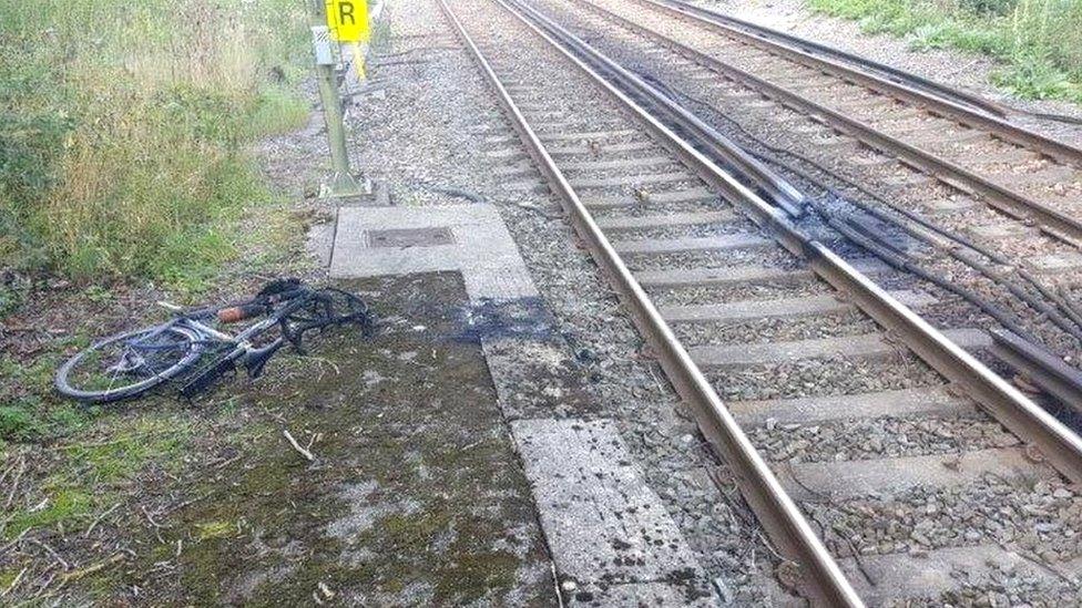 The burnt bicycle on the tracks