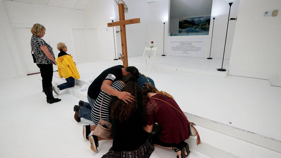 People pray in the First Baptist Church of Sutherland Springs, Texas, as the church was opened to the public as a memorial to those killed on November 12, 2017