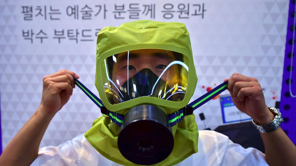 Man in gas mask during civil defence practice in Seoul