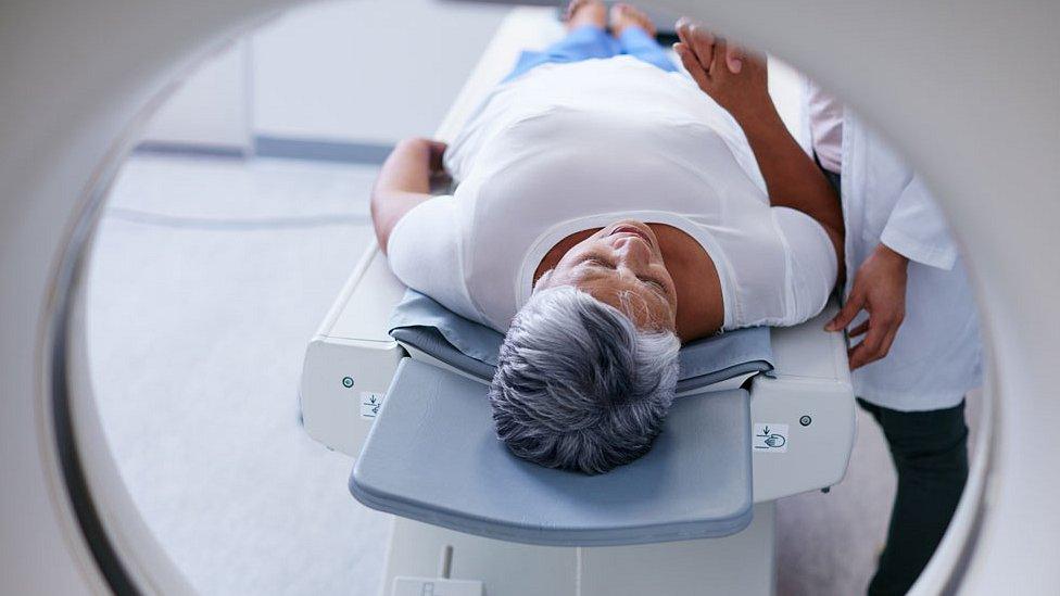 woman going through MRI machine