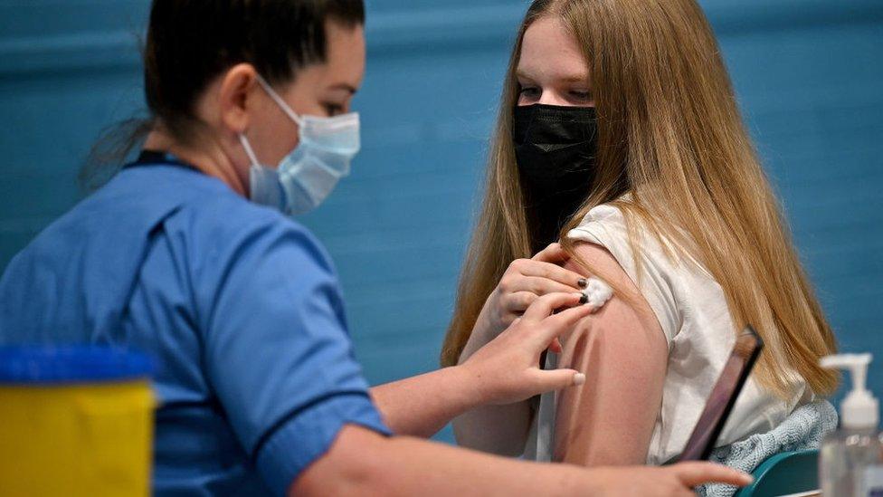 Teenager getting vaccinated