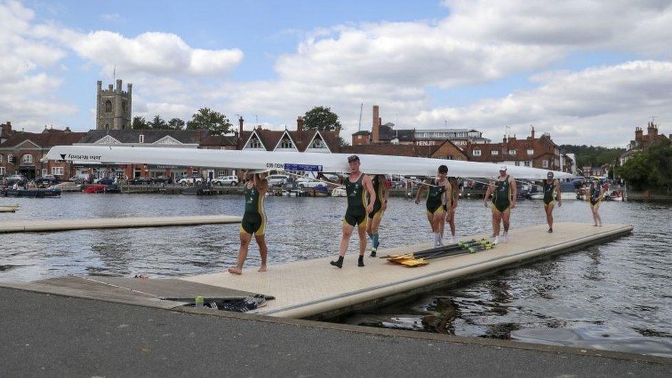 Rowers carrying boat