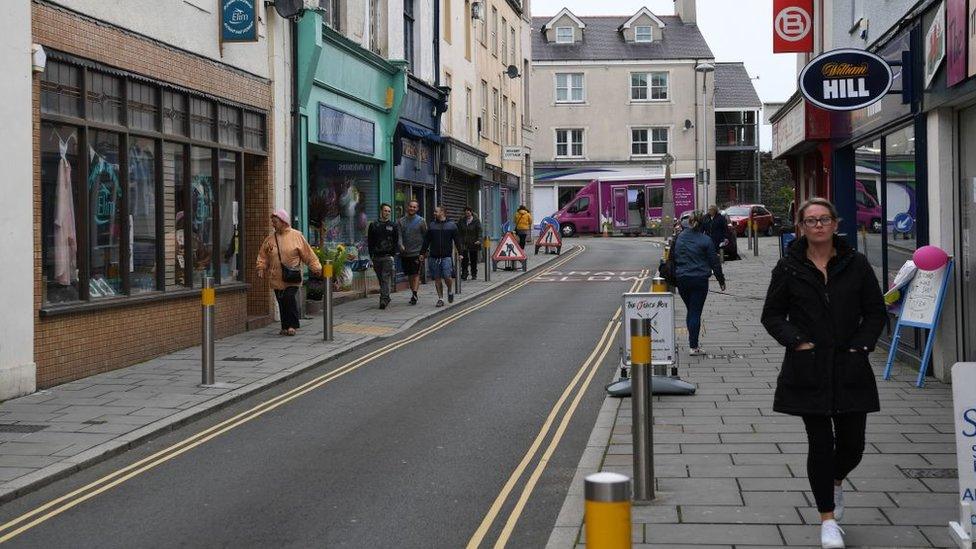 People walk past the shops on Stanley Street in Holyhead, Anglesey