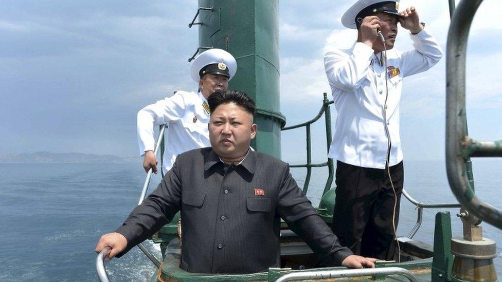 North Korean leader Kim Jong Un (front) stands on the conning tower of a submarine during an inspection in January 2016