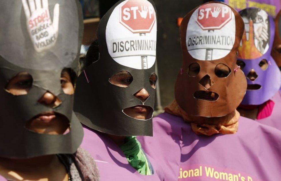 Garment workers wear masks during a rally in Dhaka, Bangladesh