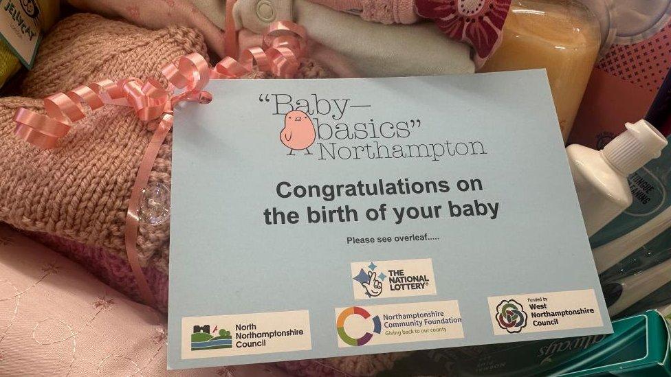 Blankets and toiletries, with a notice saying "Congratulations on the birth of your baby"