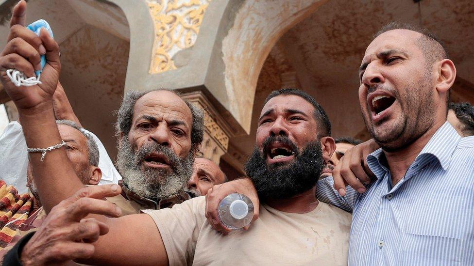 People who survived the deadly storm that hit Libya protest outside Sahaba Mosque.