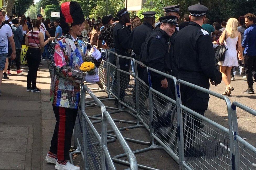 Man trying to give flowers to police