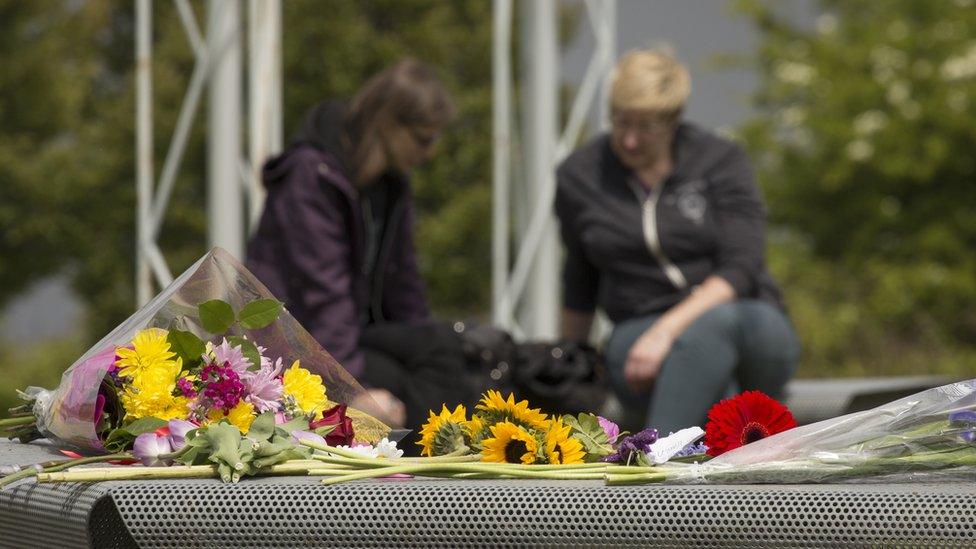 flowers in foreground, people in background