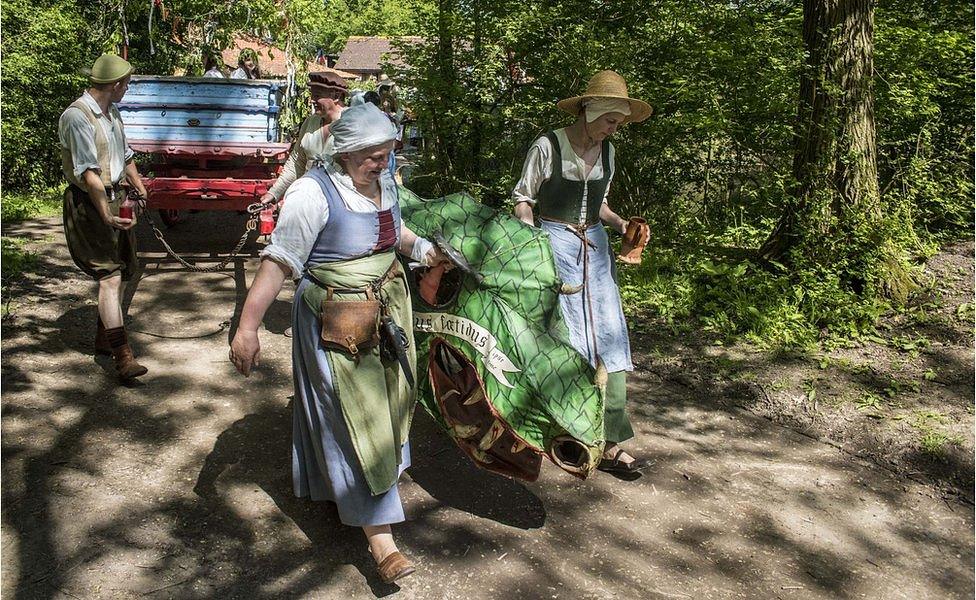 Women carry the dragon's head during the procession