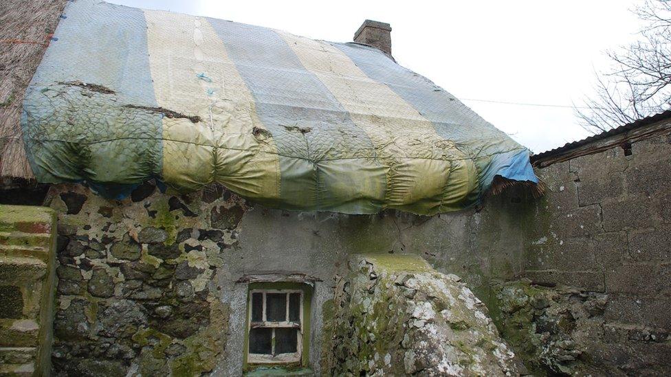 A cattle gate, covered with canvass, has been used as a temporary roof