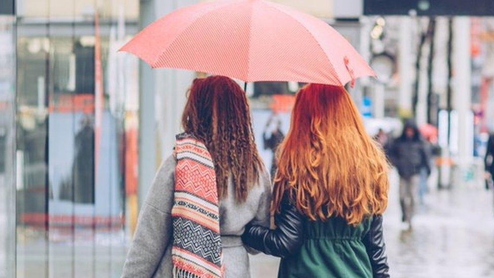 Shoppers in the rain