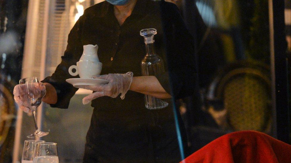 A waitress wearing a face mask in a restaurant in Dublin city centre