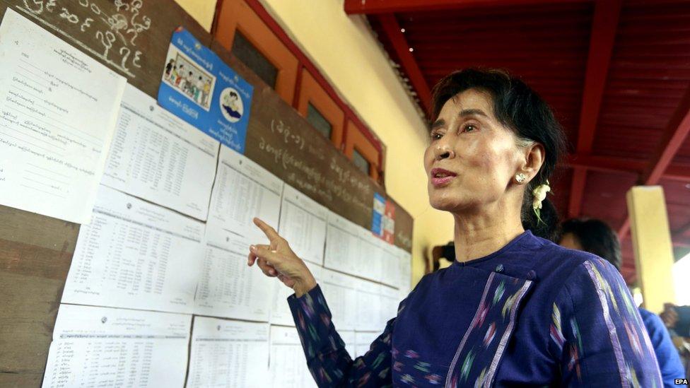 Myanmar opposition leader Aung San Suu Kyi (C) talks to media as she checks the voters list at the Wahtheinkha village in Kawmhu township, Yangon, Myanmar, 04 July 2015