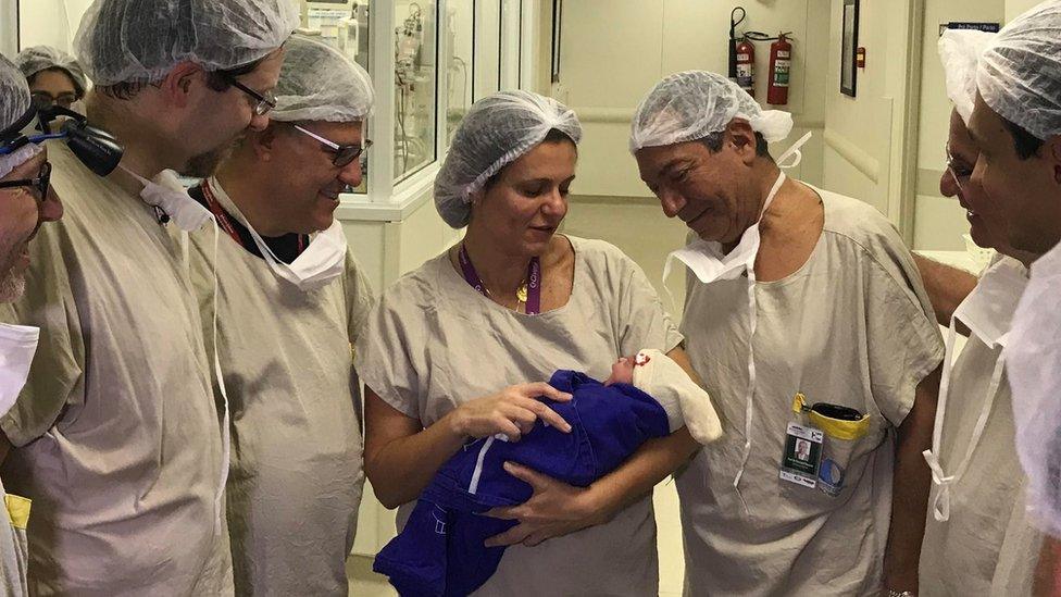 Medical team hold the baby