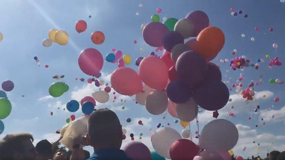 Balloons of varying colours floating up to the sky