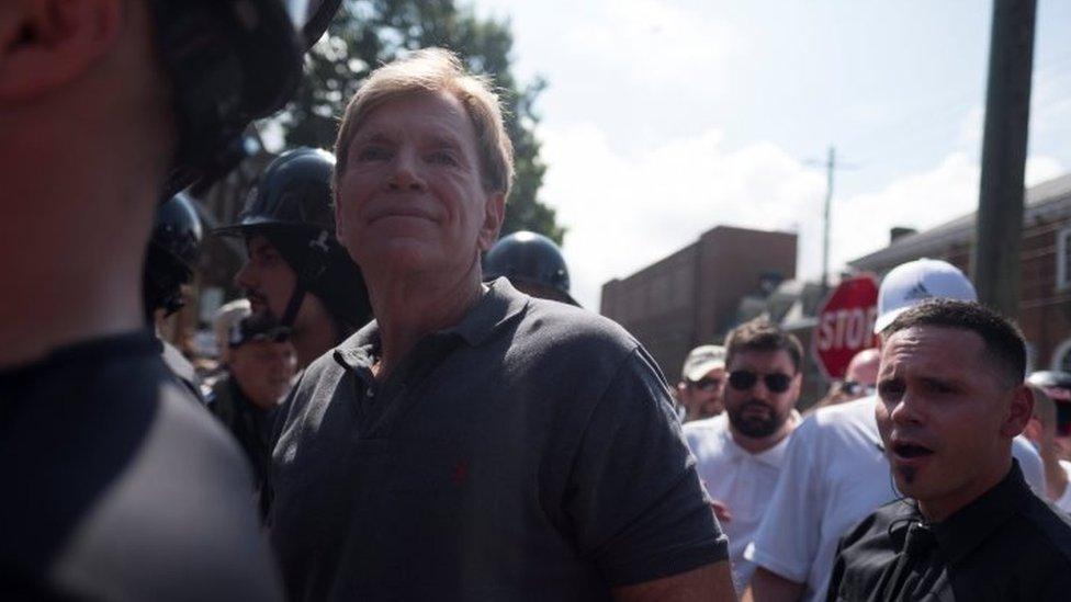 David Duke (C), participates in a rally where a crowd of white nationalists are met by a group of counter-protesters in Charlottesville, Virginia, on 12 August