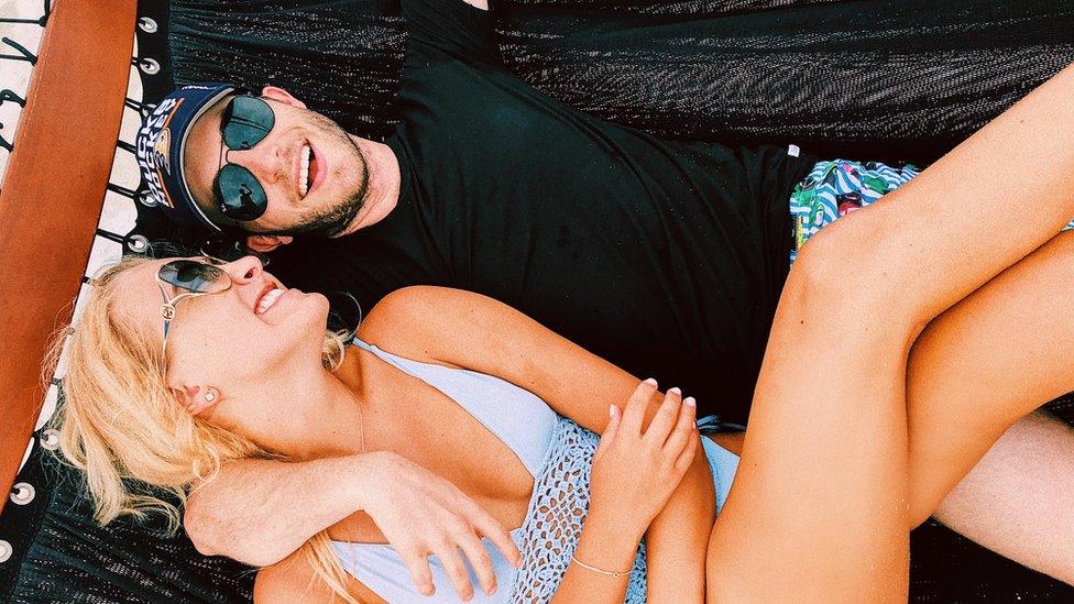 Katarina Zarutskie and her boyfriend Nicolò lying down in holiday snap