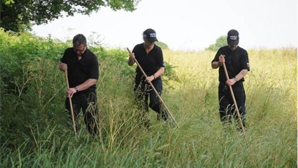 Police searching a field in Connah's Quay