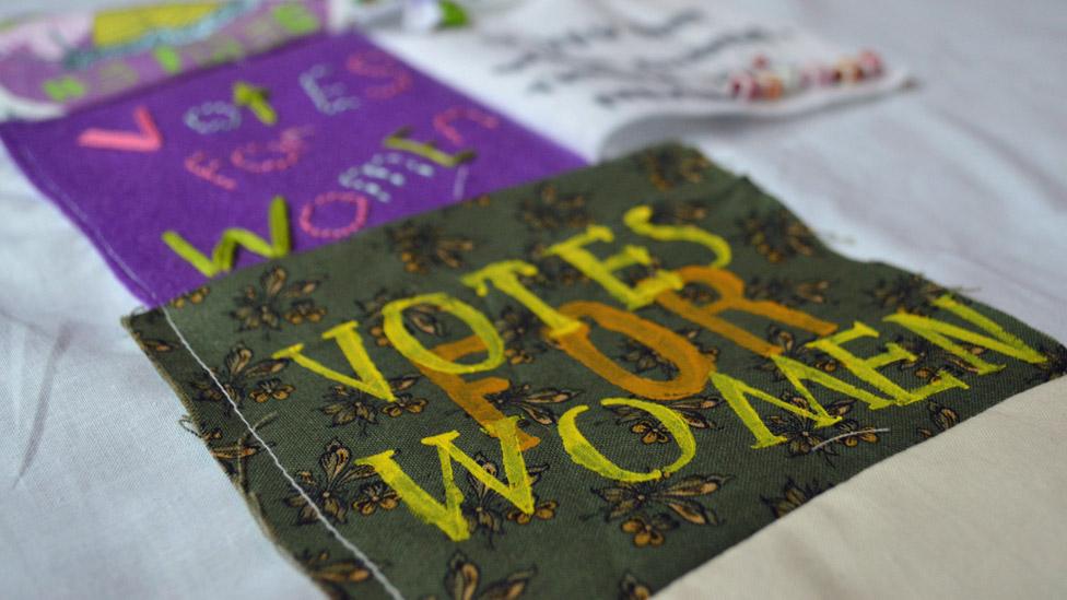 "Votes For Women" patch on Girl Gang Manchester's banner