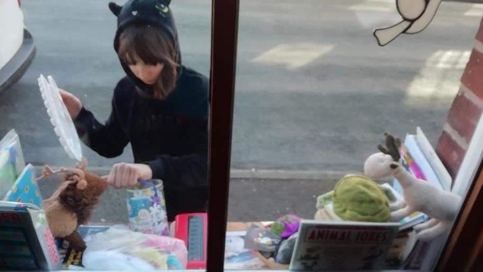 Jet outside her house, putting items on the windowsill