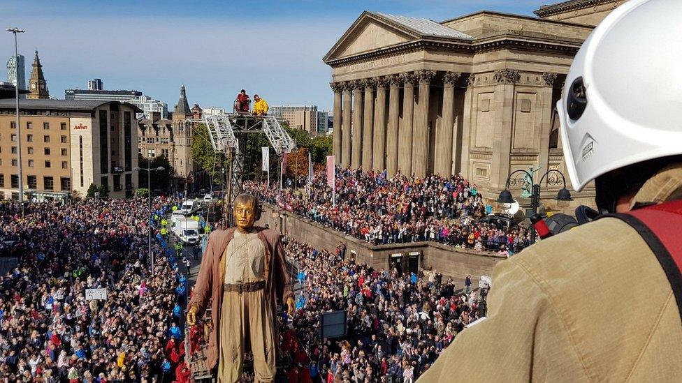 Giant man outside St George's Hall - watched by crowds