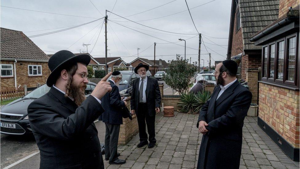 Joel Friedman (right) and colleagues looking at JCoCI's latest house purchase