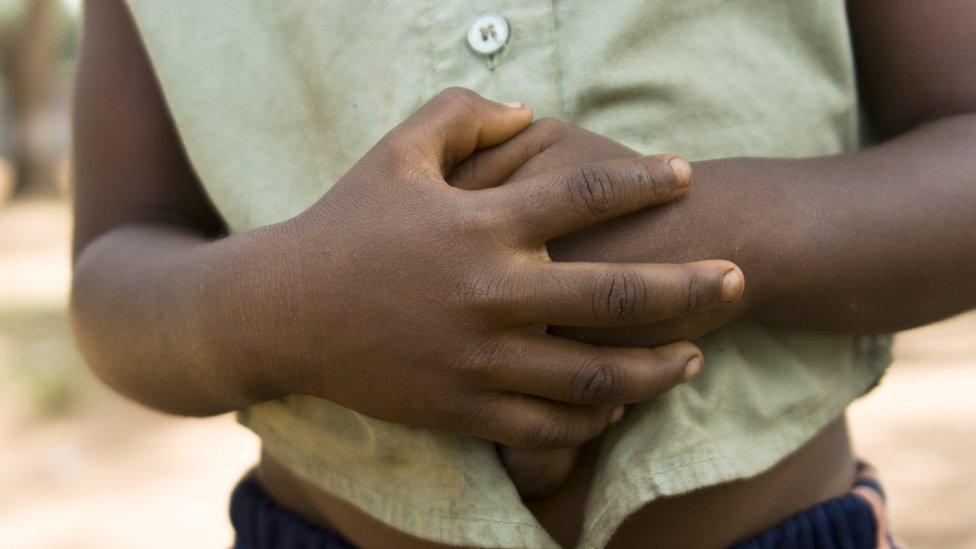 Girl holding her stomach