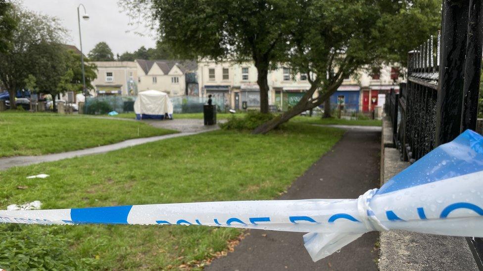 A police cordon and a forensic scene tent in a park in Bristol