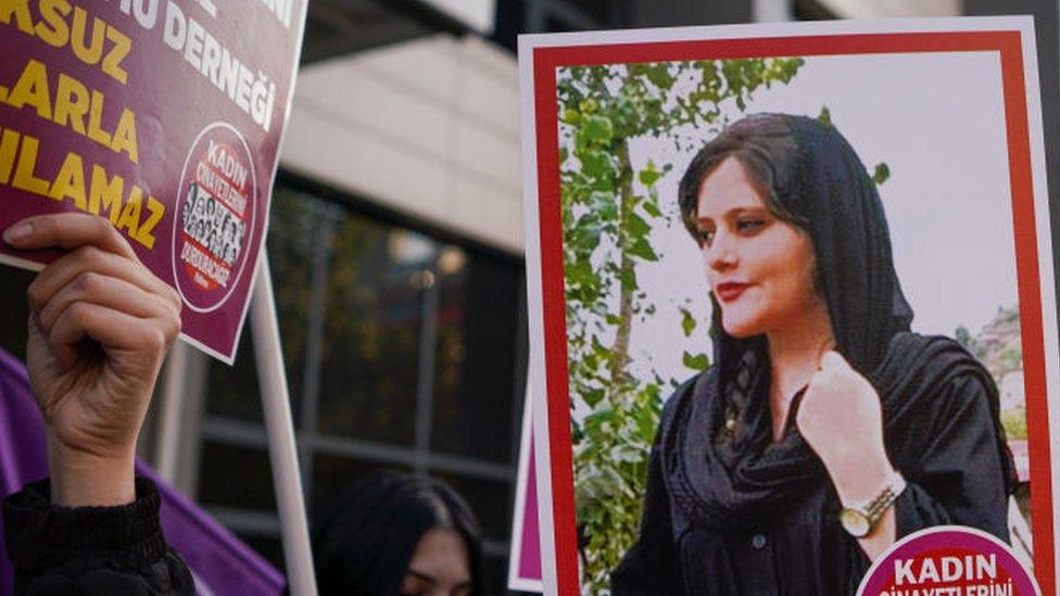 A protester holds a picture of Mahsa Amini during protests in Turkey back in 2022