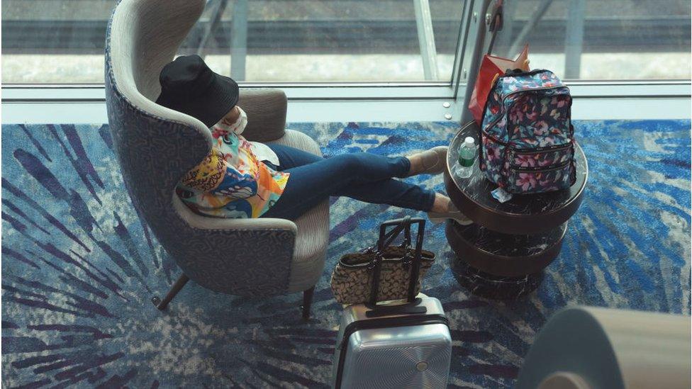 A traveller rests at the transit hall of Changi International Airport