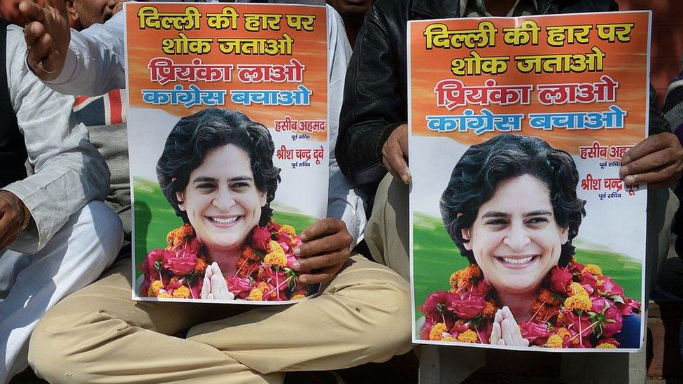 Indian Congress party workers hold pictures of Priyanka Gandhi as they shout slogans outside the All Indian Congress Committee office in New Delhi on February 10, 2015, demanding Priyanka replace Congress party vice-president Rahul Gandhi to 'save the party'. Indian Prime Minister Narendra Modi conceded defeat on February 10 in the Delhi state elections as early results showed anti-corruption campaigner Arvind Kejriwal's party set for a landslide victory.