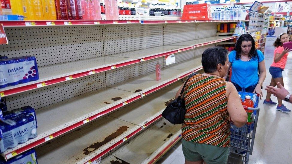 Nearly empty shelves are shown at a grocery store as Tropical Storm Dorian approaches in Cabo Rojo, Puerto Rico