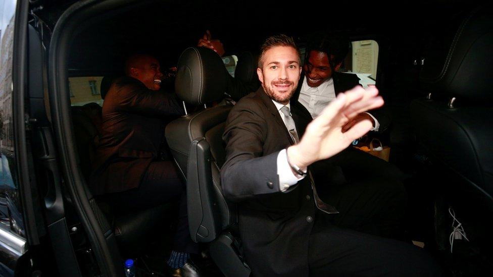 ASAP Rocky (back right) smiling widely in a car as he leaves the district court