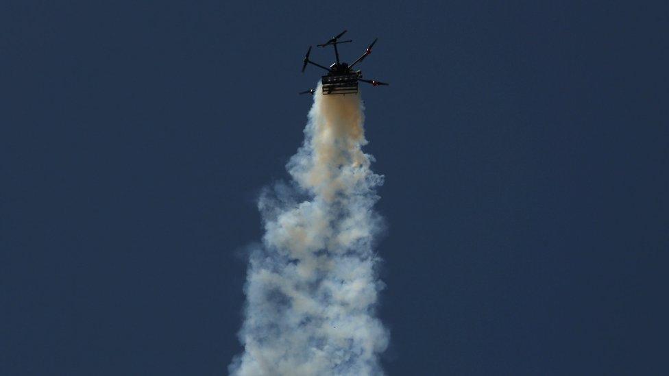 An Israeli military drone drops tear gas onto Palestinians at a protest near the Gaza-Israel border fence on 15 May 2018