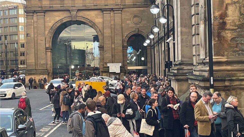 Passengers queueing for a bus outside Newcastle Central Station