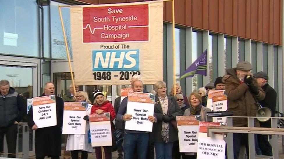 Campaigners carrying banners outside the meeting calling for services to be maintained