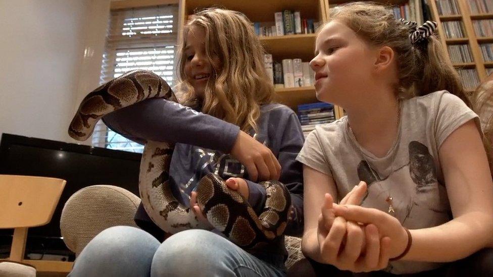 Girl holding snake at a party