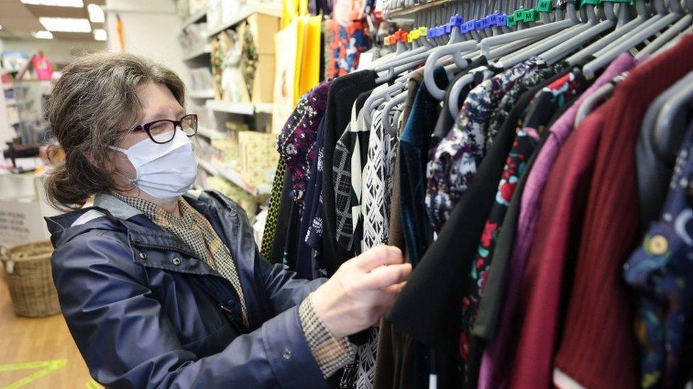 A woman shopping, looking at clothes