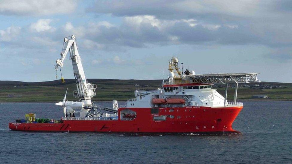 Turbine being hoisted in place from a ship