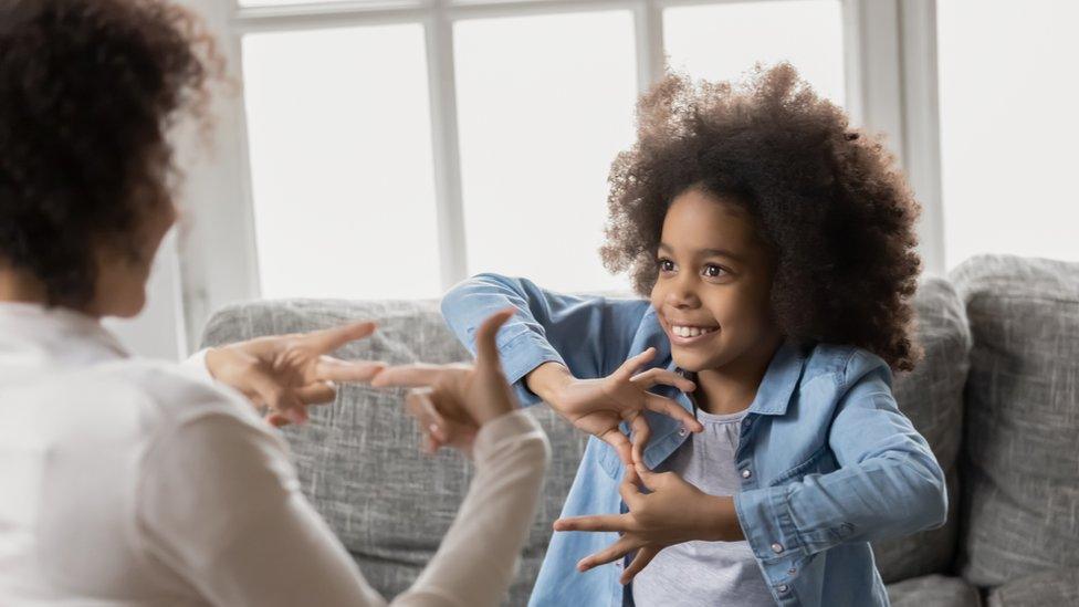 deaf-girl-communicating-with-woman.