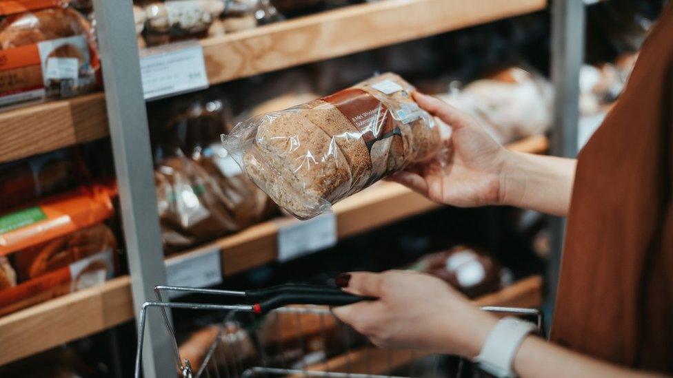 Woman checking bread label