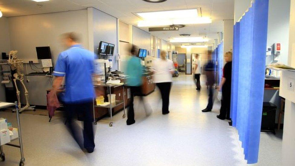 A health care area with nurses walking through